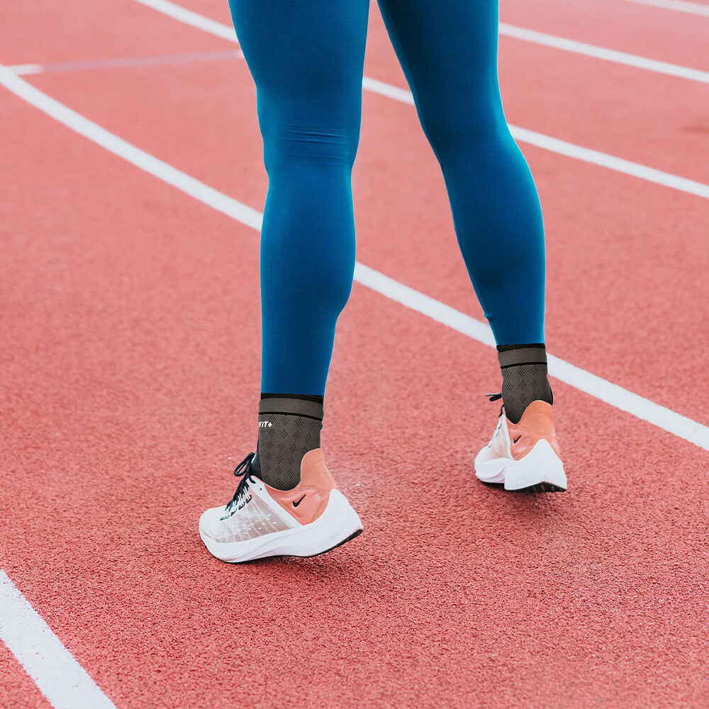 Close up of an athlete's ankles with compression sleeves on