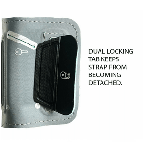 End of a phone armband strap with text on the side that says "Dual locking tab keeps strap from becoming detached"