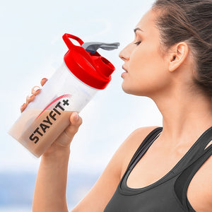 Female athlete drinking from a shaker bottle