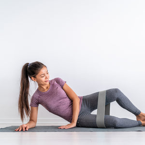 Female athlete working stretching with a fabric resistance band