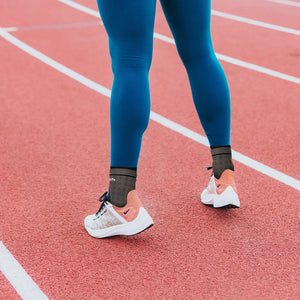 Close up of an athlete's ankles with compression sleeves on