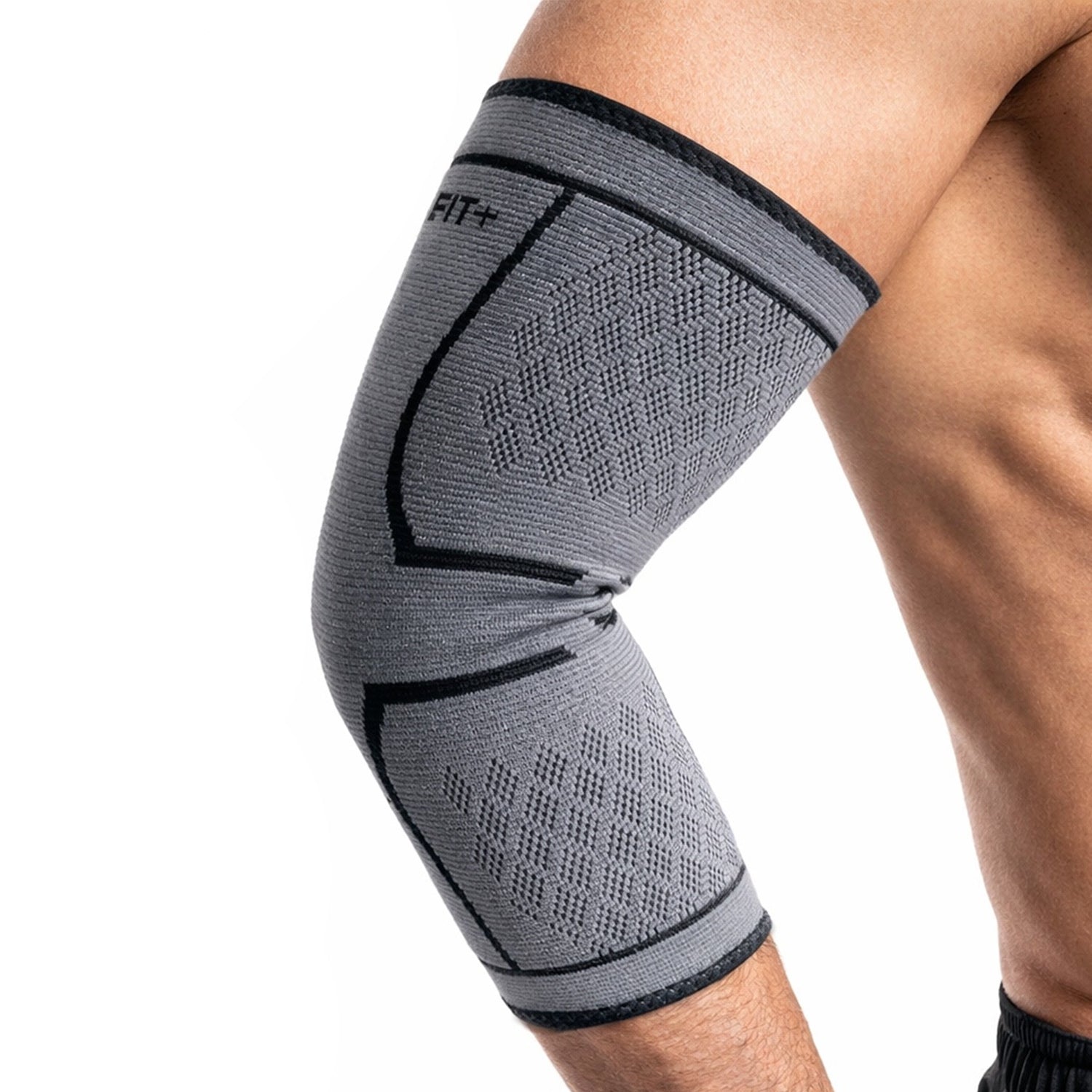 Gray elbow brace on a person's elbow with a white background