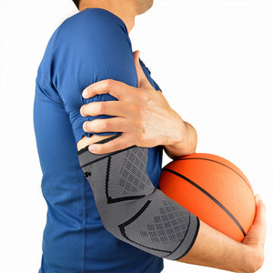 Basketball player holding his arm wrapped in a compression sleeve