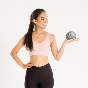 Female athlete holding a massage ball