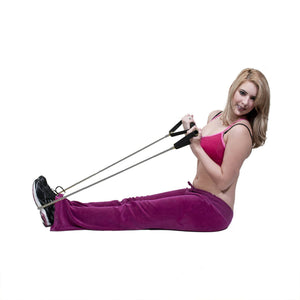 Lady stretching a grey rubber tube with handles